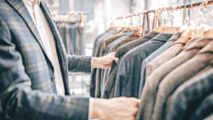 Man looking at suits in retail store