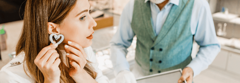 Woman trying on earrings in a luxury retail store