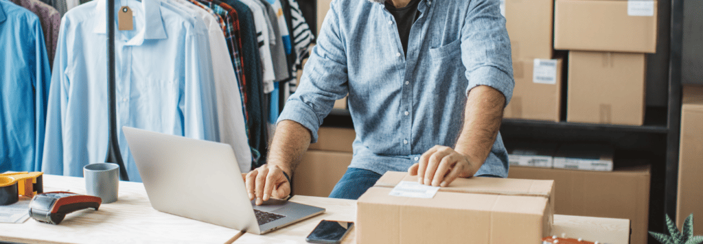 Employee looking at laptop and package