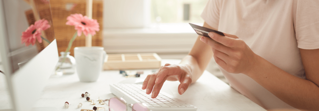 Person paying with credit card on computer