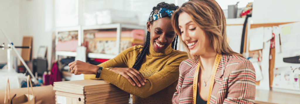 Two sales associates looking at something