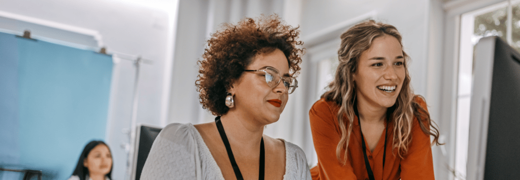 Two women looking at a computer screen