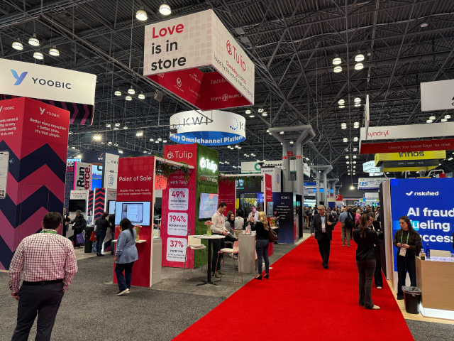 A wide-angle view of the bustling NRF 2026 conference floor in New York, symbolizing the global retail industry’s shift toward agentic execution and lifestyle orchestration.